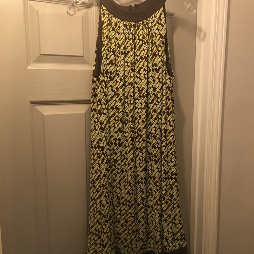 Cute little dress has a zipper in the back. Flairs out.
